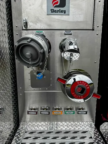 Open pump-service compartment view showing internal plumbing and pump components.